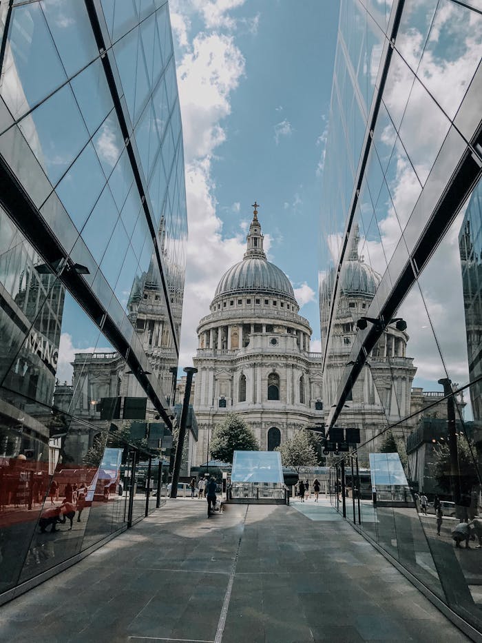 services-06 St. Paul's Cathedral in London seen through modern glass architecture.