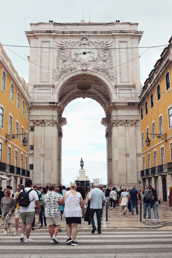 services-05 Crowds walking near the famous Arco da Rua Augusta in Lisbon, Portugal.