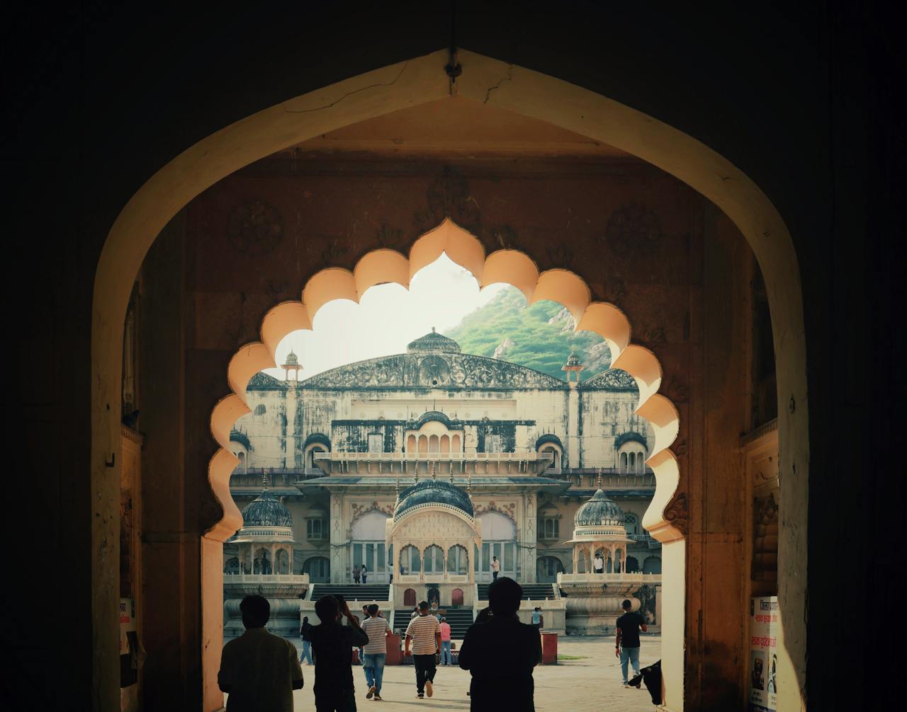 services-10 Explore the historical beauty of Alwar City Palace through an archway view.